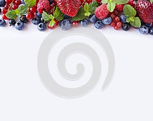 Black-blue and red fruits. Ripe red currants, strawberries, raspberries, blueberries and blackcurrants on white background.