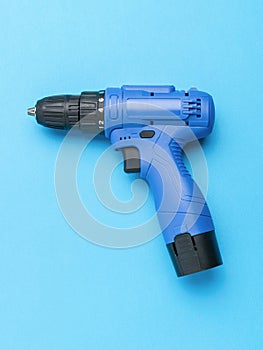 Black and blue screwdriver on a blue background