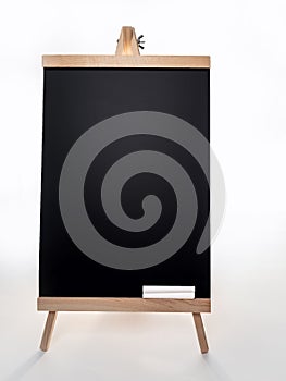 Black board with of two pieces of chalks on wooden easel isolated on white background