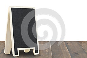 Black board on wood table isolated on a white background