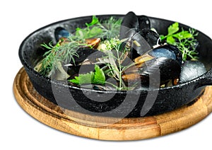 Copper pot of gourmet mussels served on a napkin