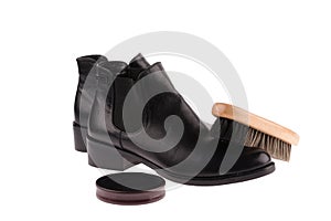 black boots with shoe brush