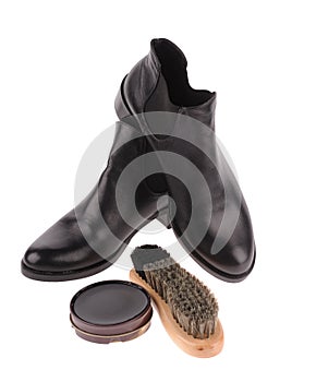 black boots with shoe brush