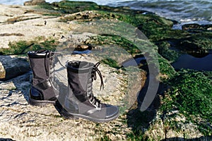 Black boots with zipped laces on foot for active holiday