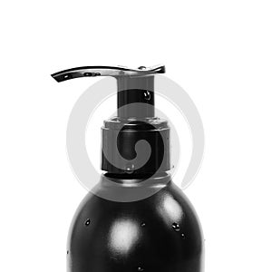 Black bottle with liquid soap dispenser. Close up. Isolated on white background