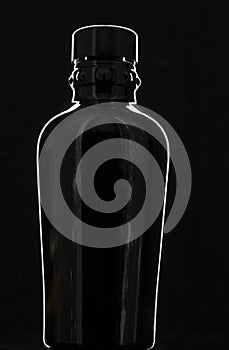 Black bottle profiled with light