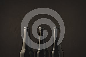 Black bottles of beer/black bottles of beer on a dark background