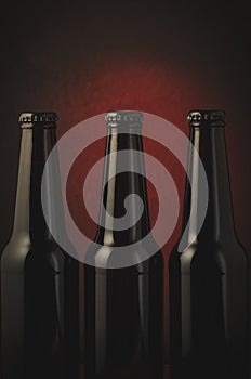 Black bottles of beer/black bottles of beer on a red background