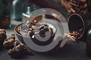 Black bowl of Common comfrey or symphytum officinale roots. Dried comfrey officinalis roots, knitbone and Bistort, Snakeweed.