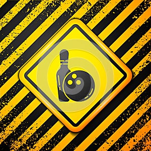 Black Bowling pin and ball icon isolated on yellow background. Sport equipment. Warning sign. Vector Illustration