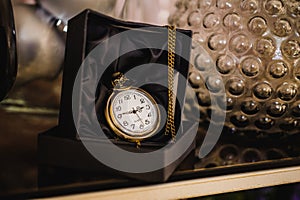 Black box with golden pocket watch