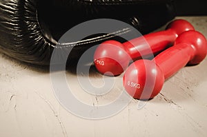 Black boxing gloves and red dumbbells/black boxing gloves and re