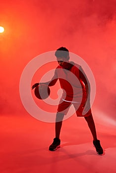 Black boy basketball player dribbling with ball