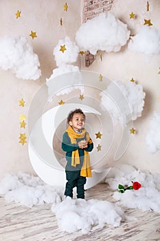 Black boy close up Portrait . Portrait of a cheerful smiling boy in a yellow scarf. Childhood. Little black boy with a rose. Congr