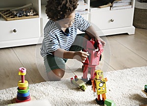 Black boy playing robot at home
