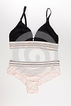 Black bra and beige panties isolated on a white background