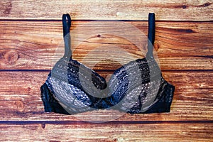 Black bra a wooden background with a copy space