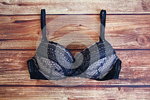 Black bra a wooden background with a copy space