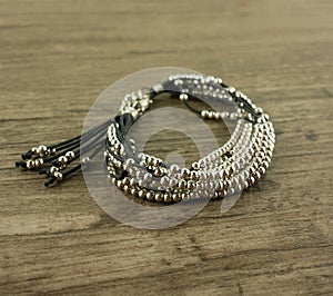 Black bracelet on wooden background