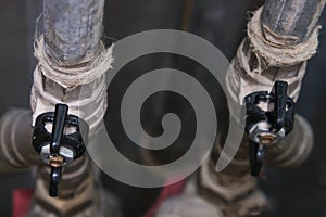 Black brass ball shut-off valves on water supply pipeline in the house, plumbing and construction concept