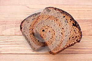 Black bread on wooden background