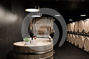 Black brick cellar, keg with wine bottle