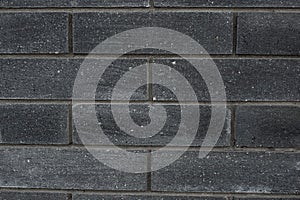 Black brick wall texture. Aged stone block masonry. Dark gloomy background