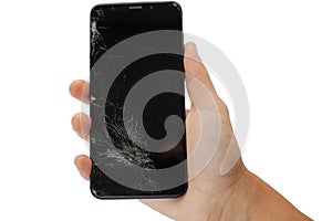 Black broken phone in hand on white background cracked touchscreen screen   isolate