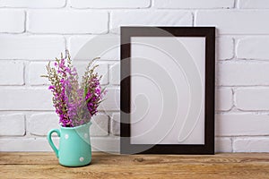 Black brown frame mockup with maroon purple flowers in mint pit