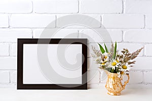 Black brown landscape frame mockup with chamomile and grass in