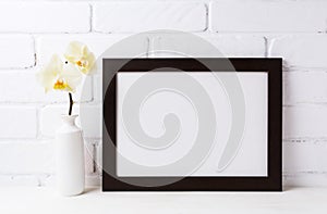 Black brown landscape frame mockup with soft yellow orchid in v