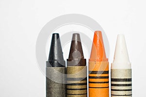 Black, Brown, Orange and White crayons