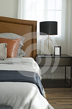 Pillows setting on bed with brown leather headboard