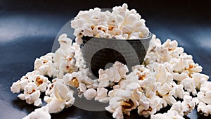 Black bucket with popcorn. photo