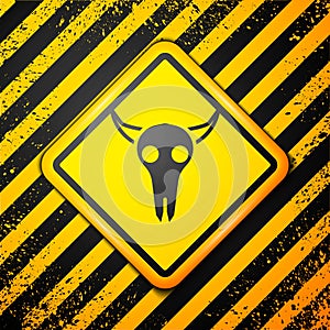 Black Buffalo skull icon isolated on yellow background. Warning sign. Vector Illustration