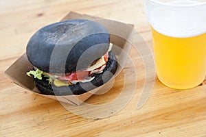 Black burger with beef stew and cheese with tomato and salad lea