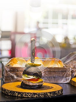 Black burger buns with chees and pickle at the local shop in the market Thailan