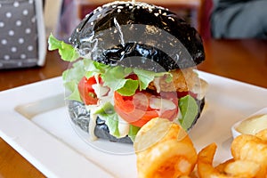 Black burger, cheese, tomatoes, mayonnaise, french fries