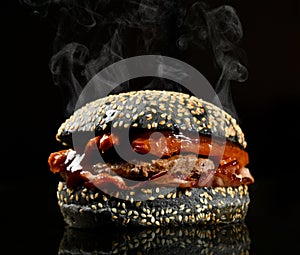 Black burger cheeseburger bbq sandwich with beef cheese and fresh vegetables tasty hot fast food black background