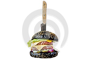 Black Burger on a wooden chopping Board. Isolated on white background.