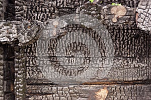 Black burnt wall of house of wooden planks with embossed texture. background for copy space