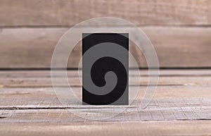 Black business cards isolated on old wood background