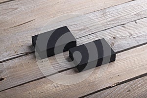 Black business cards on old wood background