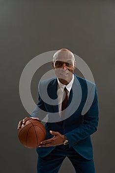 Black business man dribling with basketball ball