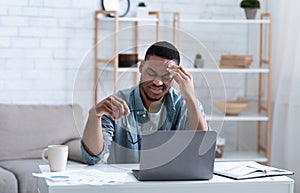 Black Business Man Having Headache Touching Head Sitting At Workplace