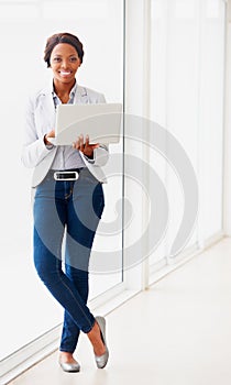 Black business woman, laptop and portrait by window, smile and typing for proposal, project and pride in workplace