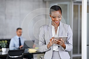 Black business woman using digital tablet in meeting room