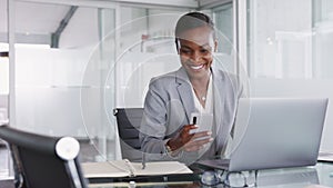 Black business woman working on mobile phone and smiling at camera