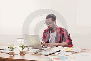 Black businessman in casual office, work with laptop