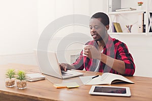 Black businessman in casual office, work with laptop